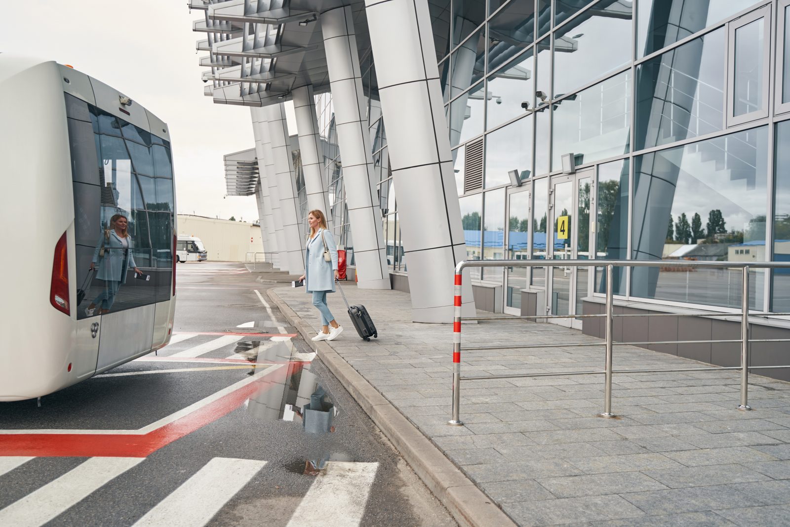 Passenger approaching a coach outside an airport terminal