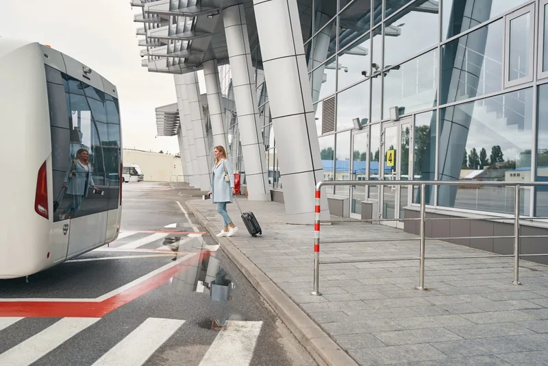 Passenger approaching a coach outside an airport terminal